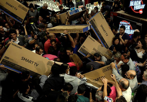  Shoppers reach out for television sets as they compete to purchase retail items on Black Friday at a store in Sao Paulo, Brazil, November 23, 2017. Photo by Paulo Whitaker 