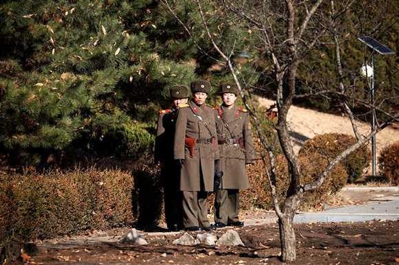  North Korean soldiers keep watch toward the south next to a spot where a North Korean has defected crossing the border on November 13, at the truce village of Panmunjom inside the demilitarized zone, South Korea. Photo by Kim Hong-Ji 