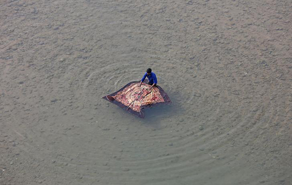  A man washes a blanket on the banks of the river Tawi in Jammu. Photo by Mukesh Gupta 