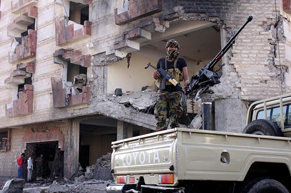  A police trooper mans a machine gun mounted on a patrol truck at the site of a car bomb attack outside the Finance Ministry offices in the southern port city of Aden, Yemen November 29, 2017. Photo by Fawaz Salman 