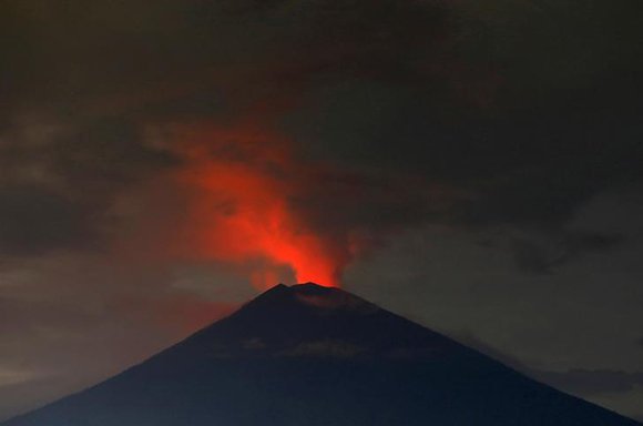  Lava, inside the crater of Mount Agung volcano, reflects off ash and clouds, while it erupts, as seen from Amed, Karangasem Regency, Bali, Indonesia November 30, 2017. Photo by Darren Whiteside 