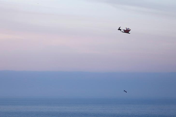  A 10-foot long remote controlled flying Santa makes a test flight over the ocean in Carlsbad, California, U.S. Photo by Mike Blake 