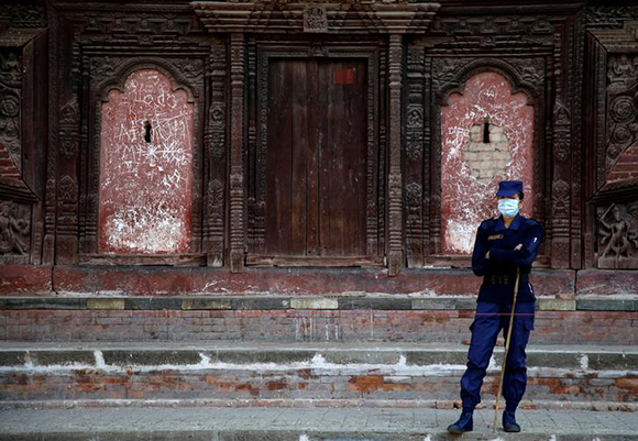  A police personnel stands guard near the polling station at Hanumandhoka Durbar Square, a day ahead of the parliamentary and provincial elections in Kathmandu, Nepal December 6, 2017. Photo by Navesh Chitrakar 