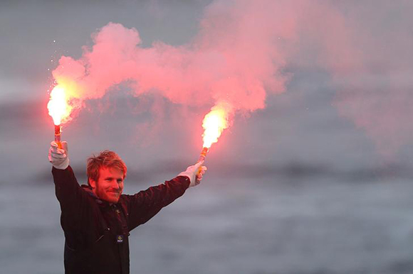  French skipper Francois Gabart celebrates with safety flares as he sails the trimaran Macif into Brest harbour following his successful solo, non-stop around the world record of 42 days, 16 hours, 40 minutes and 35 seconds, in Brest, France December 17, 2017. Photo by Stephane Mahe 