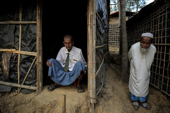  Rohingya refugee Omar Khan (L), who says he is a former general of Myanmar army, poses for a picture as he sits at his temporary shelter at the Kutupalong refugee camp near Cox's Bazar, Bangladesh December 19, 2017. Photo by Marko Djurica 