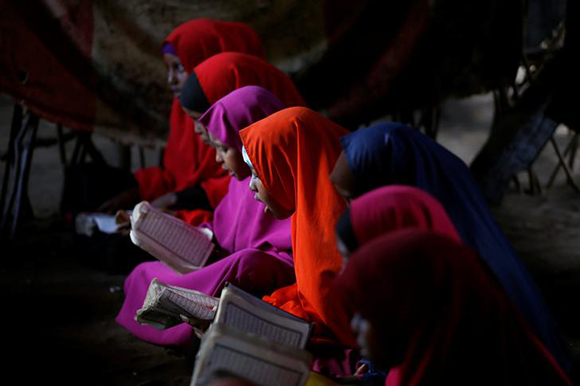  Somali refugees study the Quran at a school in the Dadaab refugee camp, Kenya December 19, 2017. Photo by Baz Ratner 