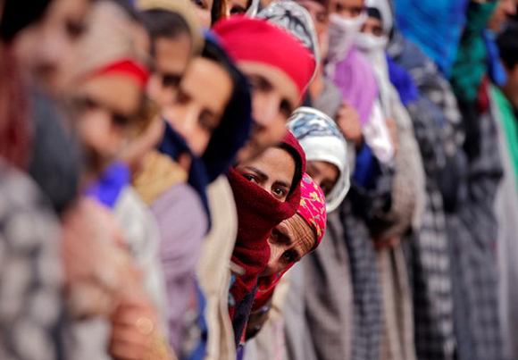  Women gather to watch the body of Noor Mohammad Tantray, a suspected militant, who according to the local media was killed in a gunbattle with Indian security forces, during his funeral in south Kashmir's Tral town December 26, 2017. Photo by Danish Ismail 