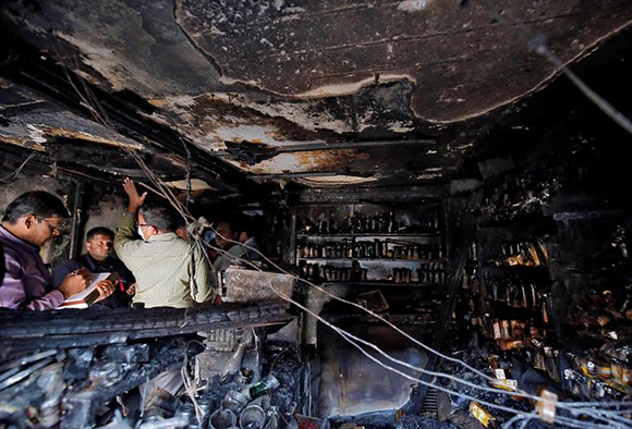  Forensic officials inspect inside a burnt restaurant after a fire in which, according to local media, five people died in Bengaluru, India, January 8, 2018. Photo by Abhishek N. Chinnappa 