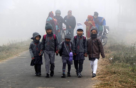  Students walk towards their school on a foggy winter morning on the outskirts of Agartala, India, January 12, 2018. Photo by Jayanta Dey 