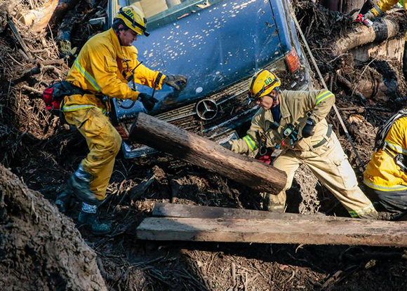  Rescue workers scour through cars for missing persons after a mudslide in Montecito, California, U.S. January 12, 2018. Photo by Kyle Grillot 