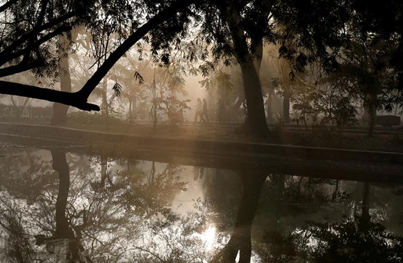  People walk by a lake at a public park on a foggy winter morning in New Delhi, India January 19, 2018. Photo by Saumya Khandelwal 