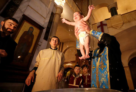  A baby is baptised during a mass baptism ceremony at the Holy Trinity Cathedral in Tbilisi, Georgia, January 21, 2018. Photo by David Mdzinarishvili 