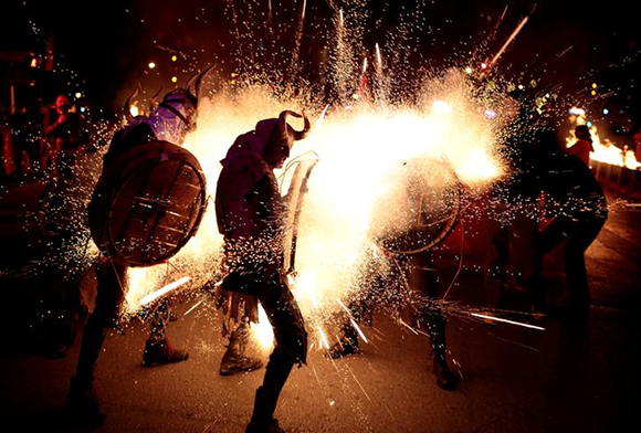  Revellers dressed as devils walk among fireworks during "Correfocs" (fire runs), traditional celebrations in eastern Spain with people dressed as dancing devils while lighting fireworks among crowds of spectators, to mark the end of the local festivities in Palma de Mallorca, Spain, January 21, 2018. Photo by Enrique Calvo 