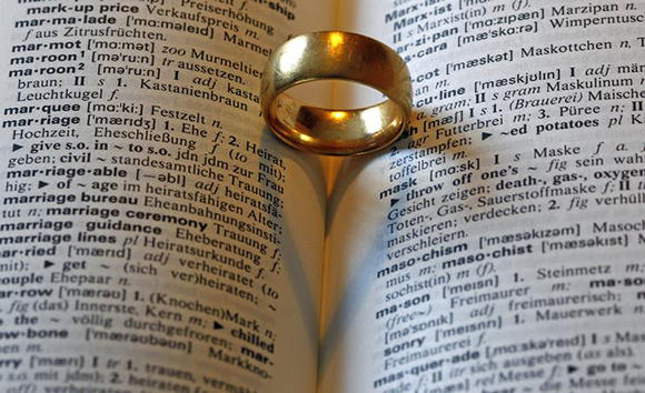  A wedding ring casts a heart shaped shadow next to the words marriage (hochzeit) in an English-German dictionary in Munich Photo by Michaela Rehle 