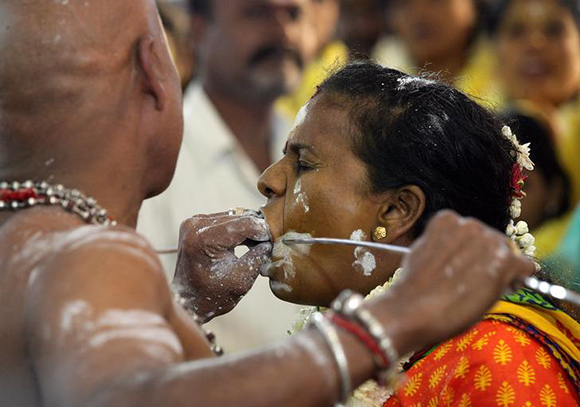  A Hindu devotee reacts as she gets her cheeks pierced with a metal skewer during the Thaipusam festival in Chennai, India, January 31, 2018. Photo by P. Ravikumar 