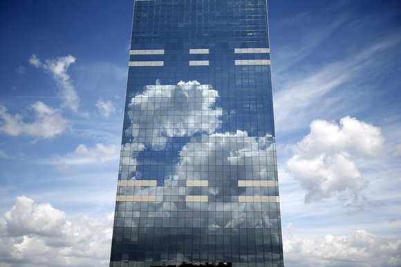  Clouds are reflected in the Midi Tower, the headquarters of the National Pensions Office, in downtown Brussels in Belgium. Photo by Charles Platiau 