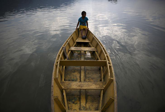  A boy sits on a boat at Phewa Lake in Pokhara, west of Nepal's capital Kathmandu Photo by Navesh Chitrakar 