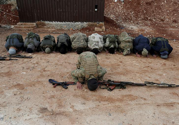  Turkey-backed Free Syrian Army fighters pray at a training camp in Azaz, Syria January 21, 2018. Photo by Osman Orsal 