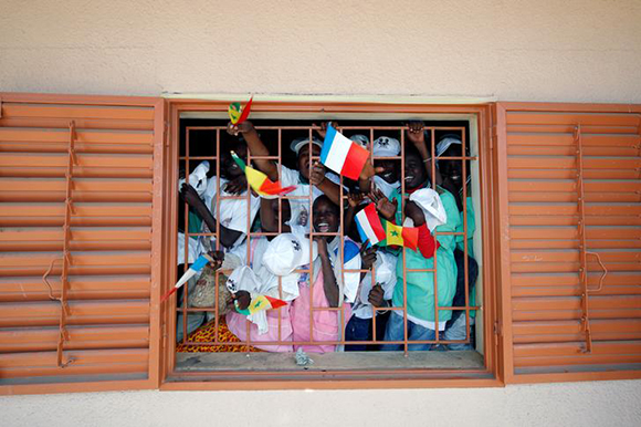  Pupils shout from their classroom at the College Bel-Air secondary school as Senegalese President Macky Sall and French President Emmanuel Macron (both not pictured) arrive for its inauguration in Dakar, Senegal, February 2, 2018. Photo by Philippe Wojazer 