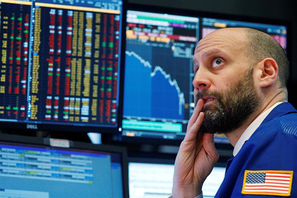  A trader reacts as he watches screens on the floor of the New York Stock Exchange in New York, U.S. Photo by Brendan McDermid 