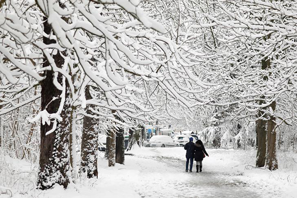  People walk on a snow-covered path in the Bois de Vincennes in Paris, France, as winter weather with snow and freezing temperatures arrive in France, February 7, 2018. Photo by Charles Platiau 