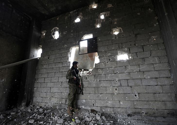  A Turkey-backed Free Syrian Army fighter holds his weapon in the town of Marea in northern Aleppo countryside, Syria. Photo by Khalil Ashawi 