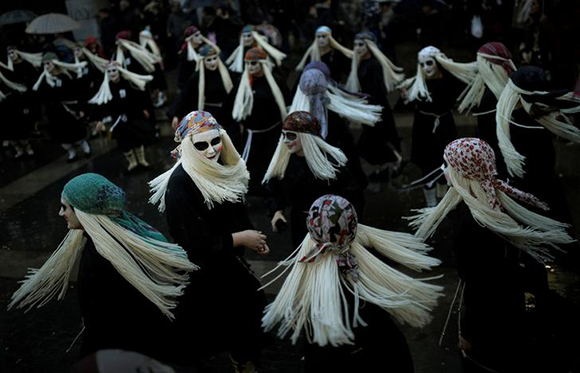  Townswomen dressed as Lamia, with their faces painted white and eyes darkened, sing and dance on Carnival Sunday, in the Basque coastal town of Mundaka, northern Spain, February 11, 2018. Photo by Vincent West 