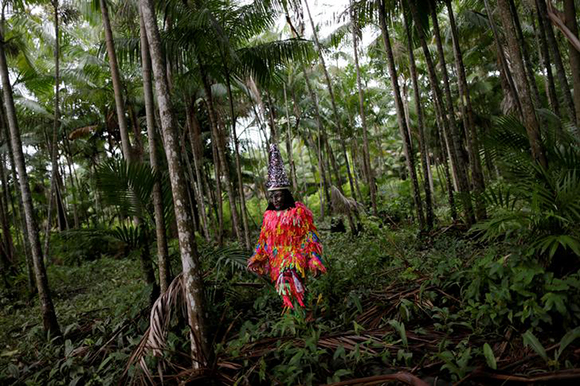  A member of the "Bloco Bambas da Folia" group poses for photo during Carnival of the Waters, where costumed and colorful boats navigate the river Pacaja, around the islands near the city of Cameta, Brazil Photo by Ueslei Marcelino 