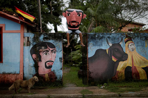  A member of the "Group Boi Faceiro" wears a mask known as "Cabecudos" and poses for a photo during carnival festivities in Sao Caetano de Odivelas, Brazil February 13, 2018. Photo by Ueslei Marcelino 