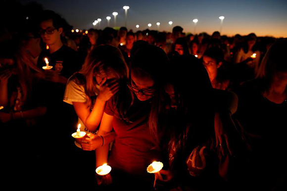  People attend a candlelight vigil for victims of yesterday's shooting at nearby Marjory Stoneman Douglas High School, in Parkland, Florida, U.S. February 15, 2018. Photo by Carlos Garcia Rawlins 