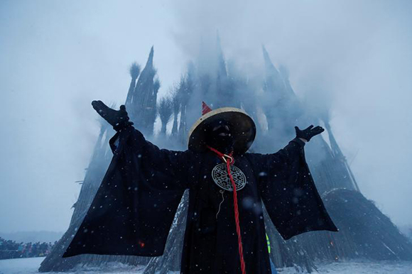  Artist German Vinogradov acts in the performance of the burning of installation, devoted to Maslenitsa, or Pancake Week, a pagan holiday marking the end of winter, in the village of Nikola-Lenivets, Kaluga region, Russia. Photo by Maxim Shemetov 