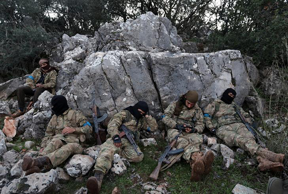  Turkish-backed Free Syrian Army fighters rest near the city of Afrin, Syria February 19, 2018. Photo by Khalil Ashawi 