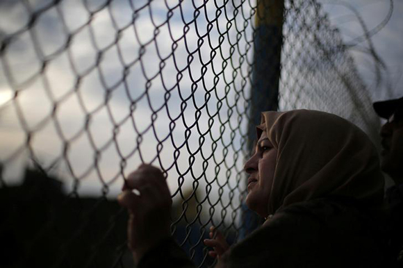  A Palestinian woman waits for her relatives to return into Gaza after the Egyptian Authority opened the Rafah Border Crossing for one day, in the southern Gaza Strip February 19, 2018. Photo by Ibraheem Abu Mustafa 