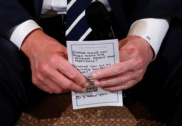  U.S. President Donald Trump holds his prepared questions as he hosts a listening session with high school students and teachers to discuss school safety at the White House in Washington, U.S., February 21, 2018. Photo by Jonathan Ernst 