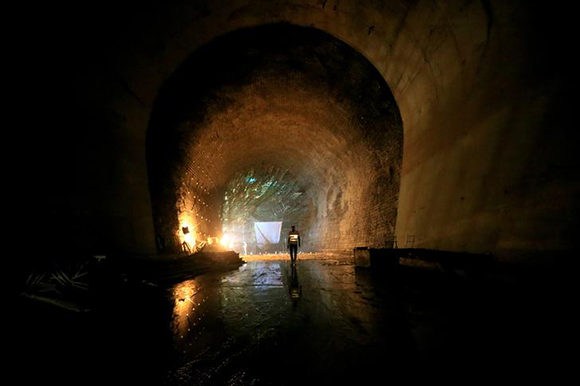  A contractor walks in a tunnel at the construction site at Karuma 600 megawatts hydroelectric power project under construction on River Nile, Uganda. Photo by James Akena 