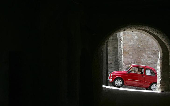  A member of the Italian Fiat 500 car club drives during a rally at the Fossato di Vico village in central Italy. The new model of the Fiat Cinquecento (500) will be officially launched in Turin. Photo by Alessandro Bianchi 