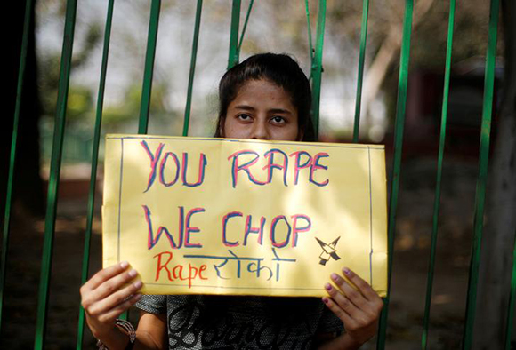  A girl holds a placard as she takes part in a movement against rapes on the occasion of International Women’s Day in New Delhi, India, March 8, 2018. Photo by Adnan Abidi 