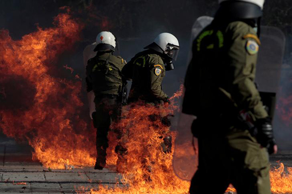  A riot police officer is engulfed in flames during a demonstration called by self-proclaimed anarchists from the Balkans against nationalism in Thessaloniki, Greece, March 10, 2018. Photo by Alexandros Avramidis 