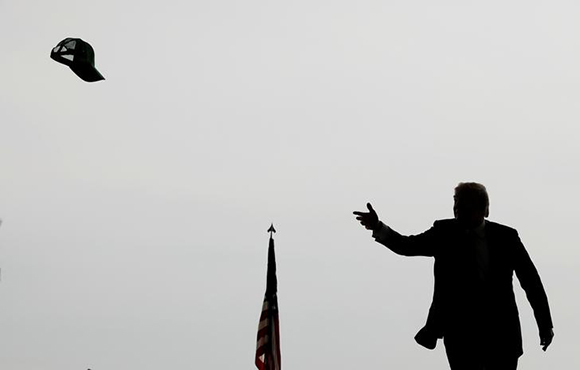  U.S. President Donald Trump tosses a hat into the crowd as he arrives to speak at Marine Corps Air Station Miramar in San Diego, California, U.S. March 13, 2018. Photo by Kevin Lamarque 
