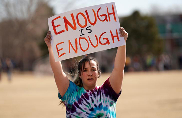  Columbine High School student Leah Zunder holds a sign during a National School Walkout to honor the 17 students and staff members killed at Marjory Stoneman Douglas High School in Parkland, Florida, in Littleton, Colorado, U.S. March 14, 2018. Photo by Rick Wilking 