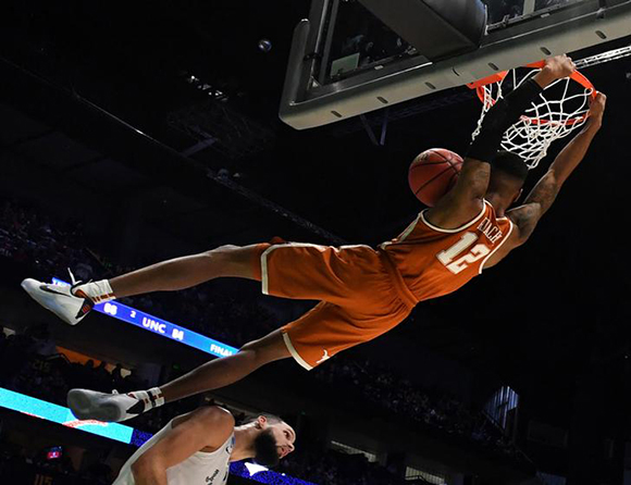  Mar 16, 2018; Nashville, TN, USA; Texas Longhorns guard Kerwin Roach II (12) dunks against Nevada Wolf Pack forward Caleb Martin (10) during the second half in the first round of the 2018 NCAA Tournament at Bridgestone Arena. Photo by Christopher Hanewinckel 