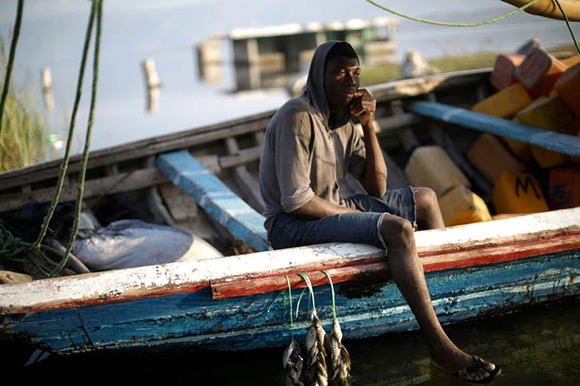  A fisherman sits on a side of a boat in the Lake Azuei on the outskirts of Fond Parisien, Haiti, March 19, 2018. Photo by Andres Martinez Casares 