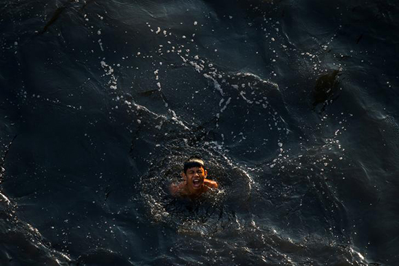  A boy swims in the polluted water of a canal in Bangkok, Thailand. Photo by Athit Perawongmetha 