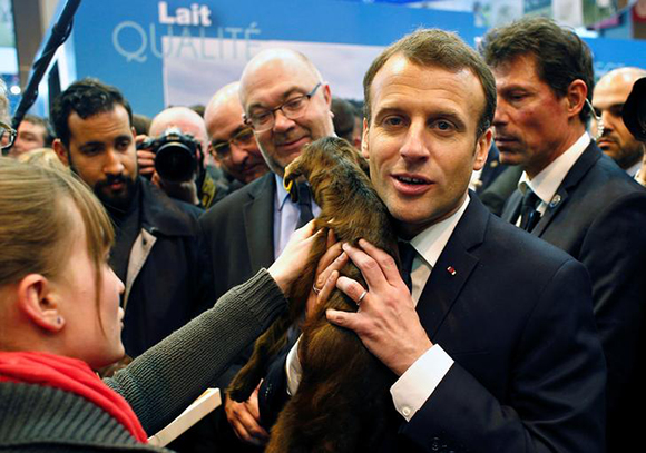  French President Emmanuel Macron holds a young goat as he visits the 55th International Agriculture Fair in Paris, France, February 24, 2018. Photo by Thibault Camus 