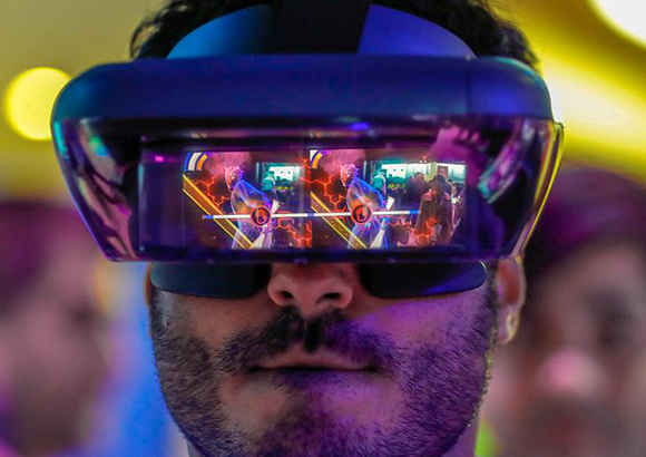  A visitor tries out Lenovo augmented reality glasses with the Star Wars Jedi Challenges during the Mobile World Congress in Barcelona, Spain Photo by Yves Herman 