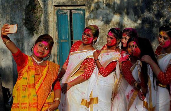  Students of Rabindra Bharati University, with their faces smeared in coloured powder, take a selfie during celebrations for Holi inside the university campus in Kolkata, India, February 26, 2018. Photo by Rupak De Chowdhuri 