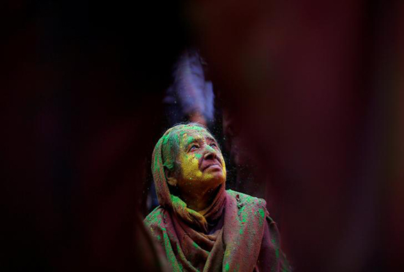  A widow daubed in colours takes part in Holi celebrations in the town of Vrindavan in the northern state of Uttar Pradesh, India Photo by Adnan Abidi 