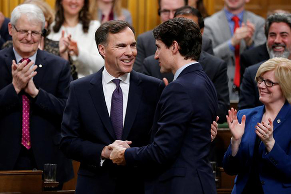  Canada's Prime Minister Justin Trudeau shakes hands with Finance Minister Bill Morneau after Morneau delivered the budget in the House of Commons on Parliament Hill in Ottawa, Ontario, Canada, February 27, 2018. Photo by Chris Wattie 