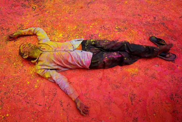  A Hindu devotee, smeared in coloured powder, takes a rest on a road during a procession for Holi celebrations in Kolkata, India Photo by Rupak De Chowdhuri 