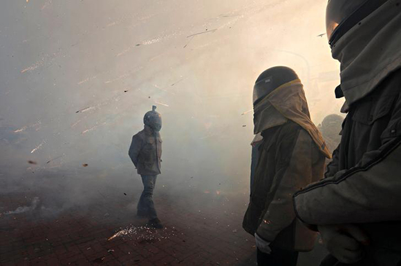  Participators wearing motorcycle helmet get sprayed by firecrackers, during 'Beehive Firecrackers' festival at the Yanshui district, in Tainan, Taiwan March 1, 2018. Photo by Tyrone Siu 